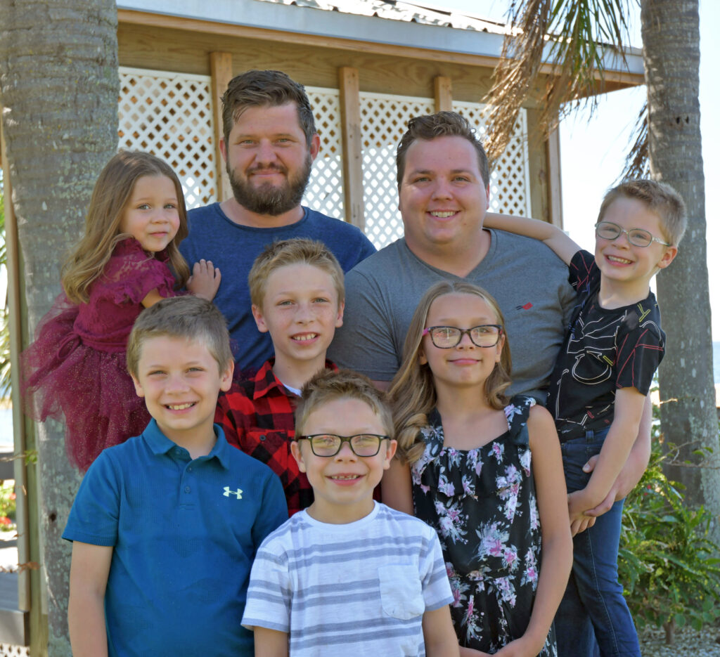 The Johnson family: Dads Daniel (top left) and Dustin (top right) with their six children
