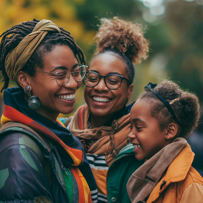 Two-mom family with child outside in the fall