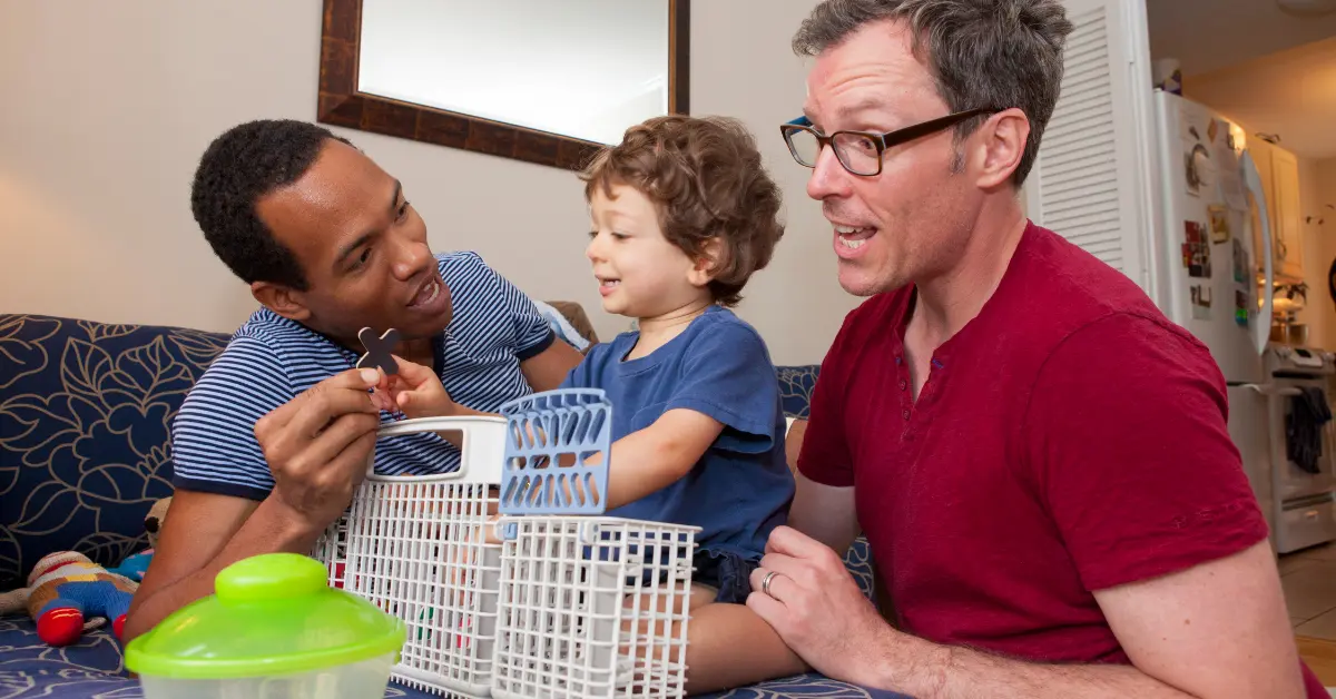 Two dads playing with their son