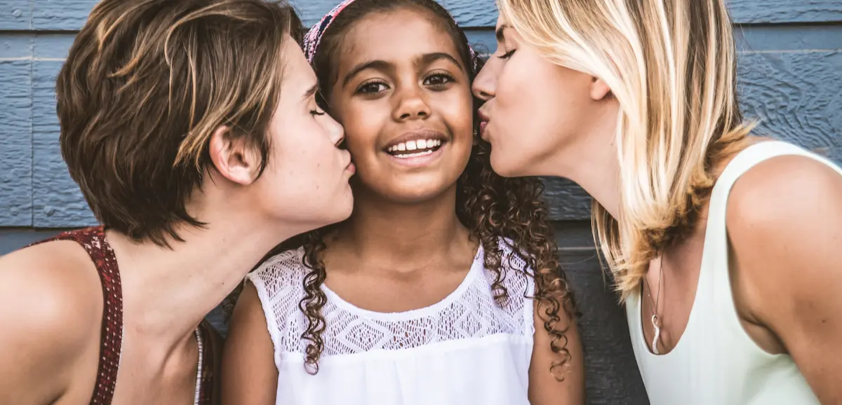 An LGBTQ+ family embraces their child