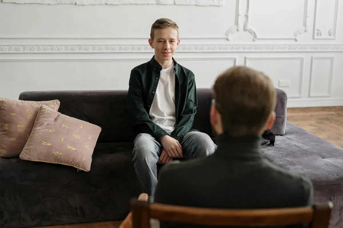 A parent having a discussion with their teen child