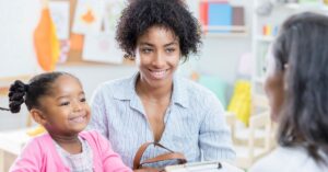 A parent with their child at a parent-teacher conference