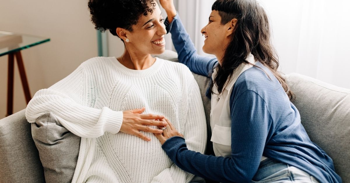 Pregnant lesbian parents embracing